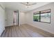 Bedroom featuring large windows, ceiling fan, closet and view into bathroom at 5604 Doral Dr, Sarasota, FL 34243