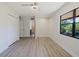 Bedroom featuring large windows, ceiling fan, closet and view into bathroom at 5604 Doral Dr, Sarasota, FL 34243