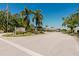Welcoming entrance to Fairway Six Woodlake with lush landscaping and clear blue skies above at 5604 Doral Dr, Sarasota, FL 34243