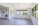 Open dining area with abundant natural light, stylish lighting, and view of greenery at 5604 Doral Dr, Sarasota, FL 34243