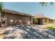 Home exterior with a large garage, well-maintained lawn, and driveway at 5604 Doral Dr, Sarasota, FL 34243