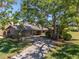 Charming home with a long driveway and mature tree providing shade at 5604 Doral Dr, Sarasota, FL 34243
