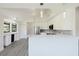 Modern kitchen with stainless steel appliances and white marble countertops and cabinetry at 5604 Doral Dr, Sarasota, FL 34243