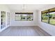 Sunlit living room with French doors and big windows offering views of the outdoors at 5604 Doral Dr, Sarasota, FL 34243