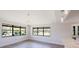 Bright open floor plan featuring vaulted ceiling, gray wood-look floors and a view to the outside at 5604 Doral Dr, Sarasota, FL 34243