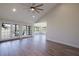 Spacious living room with gray wood-look floors, French doors, ceiling fan and vaulted ceiling at 5604 Doral Dr, Sarasota, FL 34243