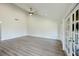 Open floor plan featuring vaulted ceiling, gray wood-look floors, ceiling fan and views to the outside at 5604 Doral Dr, Sarasota, FL 34243