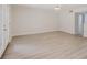 Bright living room features wood-look flooring, neutral paint, and glass doors to the outside at 5604 Doral Dr, Sarasota, FL 34243