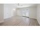 Bright living room features wood-look flooring, neutral paint, and glass doors to the outside at 5604 Doral Dr, Sarasota, FL 34243