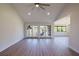 Bright open floor plan featuring vaulted ceiling, gray wood-look floors and a view to the outside at 5604 Doral Dr, Sarasota, FL 34243