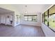 Airy living area with a view of the lawn from black framed windows and glass paneled french doors at 5604 Doral Dr, Sarasota, FL 34243