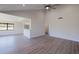 Bright open floor plan featuring vaulted ceiling, gray wood-look floors and a view to the outside at 5604 Doral Dr, Sarasota, FL 34243