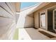 Private patio area with tiled flooring, an entryway, and exterior siding with natural lighting at 5604 Doral Dr, Sarasota, FL 34243