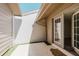 Private outdoor patio featuring tile flooring, neutral paint, and an exterior light fixture at 5604 Doral Dr, Sarasota, FL 34243