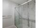 Modern shower features glass doors, a rainfall shower head, and stylish tile at 5604 Doral Dr, Sarasota, FL 34243