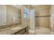 Bathroom features a granite countertop, modern fixtures, and a shower with a tiled surround and glass door at 5723 Title Row Dr, Bradenton, FL 34210