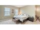 Bright bedroom with a neutral palette, cozy carpet, and a queen-sized bed near a dark gray nightstand at 5723 Title Row Dr, Bradenton, FL 34210