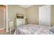 Bedroom with neutral walls, white furniture, and view of a flat screen television at 5723 Title Row Dr, Bradenton, FL 34210