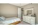 Cozy bedroom with a white dresser and mirror, featuring a bright, airy space and neutral decor at 5723 Title Row Dr, Bradenton, FL 34210