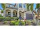 Beautiful home with tropical landscaping, a quaint front porch, and two-car garage at 5723 Title Row Dr, Bradenton, FL 34210