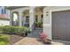 Inviting front porch with stone steps, wrought iron railing, and tropical landscaping at 5723 Title Row Dr, Bradenton, FL 34210