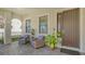 Relaxing front porch with comfortable seating, decor, and shade at 5723 Title Row Dr, Bradenton, FL 34210
