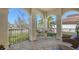 Cozy front porch with brick flooring, comfortable seating, and wrought iron railing at 5723 Title Row Dr, Bradenton, FL 34210