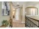 Bright hallway features a modern painting and a staircase with rod iron spindles at 5723 Title Row Dr, Bradenton, FL 34210