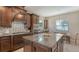 Kitchen with granite countertops, island, mosaic backsplash, stainless steel appliances, and eat-in area at 5723 Title Row Dr, Bradenton, FL 34210