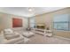 Bright, carpeted living room with large windows and modern furniture at 5723 Title Row Dr, Bradenton, FL 34210