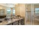 Bright main bathroom featuring granite countertops, a large mirror, and a glass shower at 5723 Title Row Dr, Bradenton, FL 34210