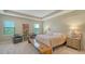 Spacious main bedroom with tray ceiling and luxurious furniture at 5723 Title Row Dr, Bradenton, FL 34210