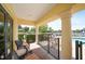 Relaxing covered patio with outdoor seating overlooking the pool, lake, and lush landscaping at 5723 Title Row Dr, Bradenton, FL 34210