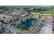 Aerial view of a residential area featuring a pond and a community pool at 6008 Madrano Dr, Sarasota, FL 34232