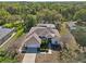 Aerial view of home with lush landscaping, screened-in pool and in a beautiful neighborhood at 610 147Th St E, Bradenton, FL 34212