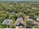 An aerial view showing the home with a beautiful pond and lush green surroundings in a serene neighborhood at 610 147Th St E, Bradenton, FL 34212