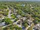 Expansive aerial view of a leafy neighborhood with well-maintained homes, close to a lake and meandering waterways at 610 147Th St E, Bradenton, FL 34212