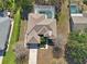 Aerial view of the house highlighting the roof, screened pool, driveway, and well-manicured landscaping at 610 147Th St E, Bradenton, FL 34212