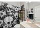 Well-lit bathroom with a skull-themed shower curtain, shelf, mirror, modern fixtures, and vanity at 610 147Th St E, Bradenton, FL 34212