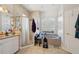 A bathroom with a shower and a bathtub with a window at 610 147Th St E, Bradenton, FL 34212