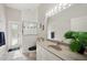 Bright bathroom featuring a modern vanity, mirror, natural light, and an enclosed shower at 610 147Th St E, Bradenton, FL 34212
