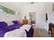 Bedroom with large windows and purple bed at 610 147Th St E, Bradenton, FL 34212