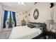 Charming bedroom featuring black and white decor, ample natural light, and a decorative mirror at 610 147Th St E, Bradenton, FL 34212