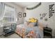 Comfortable bedroom featuring a window with natural light, cage, and decorative wall art at 610 147Th St E, Bradenton, FL 34212