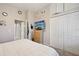 Cozy bedroom with closet, dresser, ensuite bathroom, and decorative wall art at 610 147Th St E, Bradenton, FL 34212