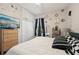 Bright bedroom featuring a large window, dresser, closet, and stylish black and white decor at 610 147Th St E, Bradenton, FL 34212