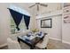 A dining room with large window, a dark wood table, and decor at 610 147Th St E, Bradenton, FL 34212