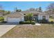 Charming single-story home with manicured landscaping, a two car garage, and a welcoming entryway at 610 147Th St E, Bradenton, FL 34212