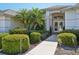 Elegant double door entry framed by well-maintained shrubs and decorative foliage at 610 147Th St E, Bradenton, FL 34212
