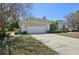 Home exterior features a two-car garage, concrete driveway and manicured shrubbery at 610 147Th St E, Bradenton, FL 34212